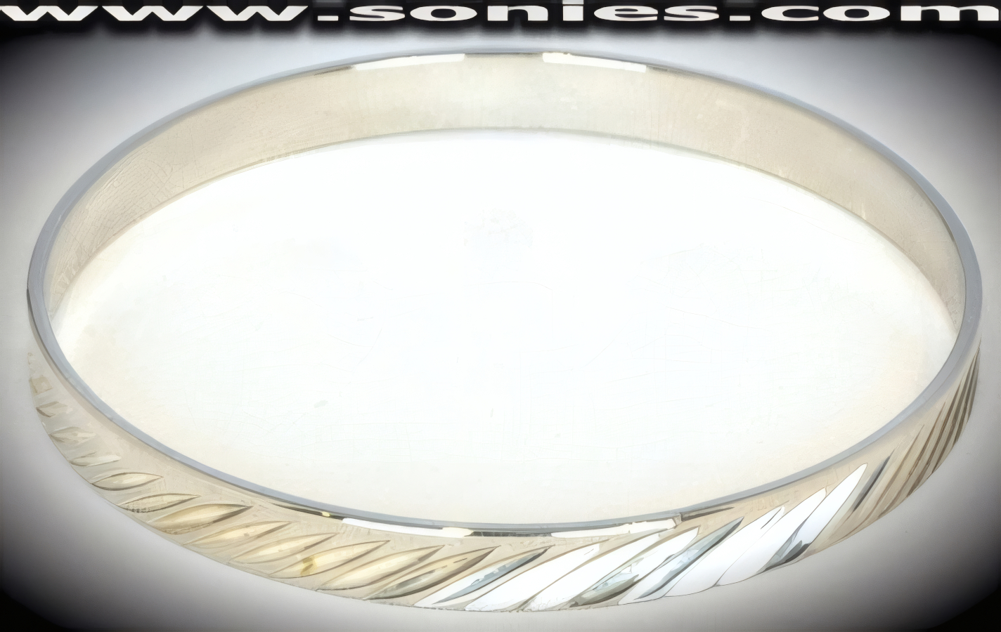 Cornucopia silver bangle bracelet with diamond cut front